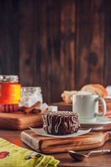 Honey cookie chocolate covered on the wooden table with coffee - pão de mel