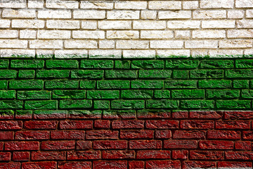 Colorful background and texture depiction of country flag on a brick wall. 