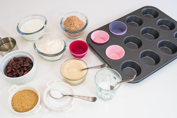 Bran muffins with dry cranberries recipe. Bran, flour, buttermilk, dry berries, and some other ingredients close up on a kitchen table