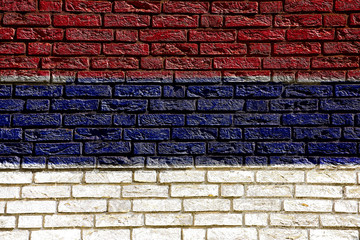 Colorful background and texture depiction of country flag on a brick wall. 