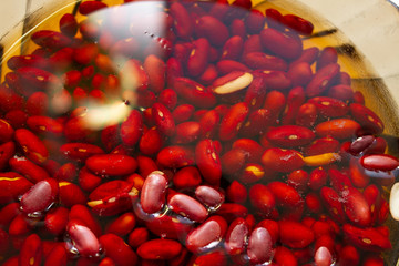 Closeup of red beans soaked in a bowl of water