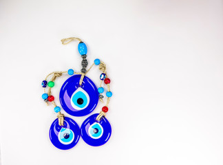 Pretty Turkish evil eye pendants isolated against a white background