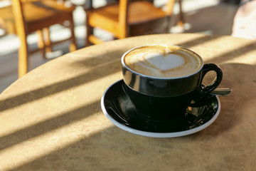late coffee on cafe table with cafe background.