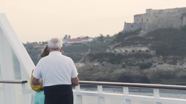 Couple enjoying the view from a boat. Taking pictures from a castle. Cuba, Havana summer exotic vacation