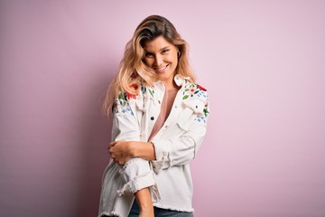 Young beautiful woman wearing fashion urban clothes, model wearing casual street style standing over pink background