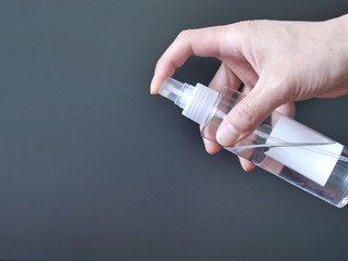 hand holding a bottle of sanitizer