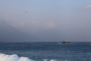 Fototapeta premium Long exposure sunrise seascape with Chinese fishing junks in the background