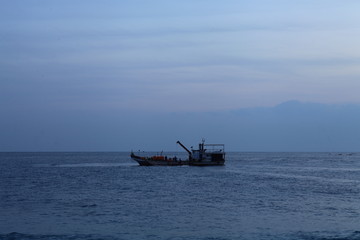 Long exposure sunrise seascape with Chinese fishing junks in the background