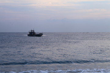 Long exposure sunrise seascape with Chinese fishing junks in the background