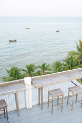 Wooden balcony, Top View with landscape views and fishing boat and lines of coconut tree                                                                                                