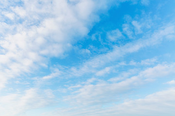 Bright blue sky in the clouds on a sunny day. Space for text. Background.