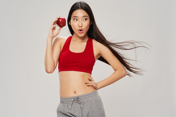 young woman holding a red apple
