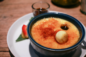 Close up image of Vanilla Crème Brûlée on a white plate.