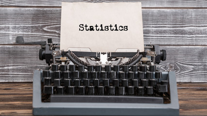 Statistics text typed on a vintage typewriter. Old paper, history