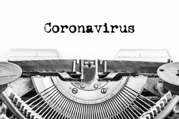 Coronavirus text typed on a vintage typewriter. History, Statistics, Covid-19 virus