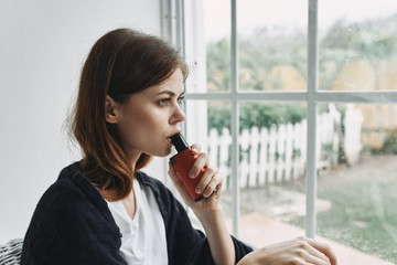 young woman looking out window