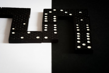 Fototapeta premium Domino blocks for mind game on a black and whit background