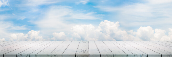 Empty wood table top with cloudy sky background for display or montage product
