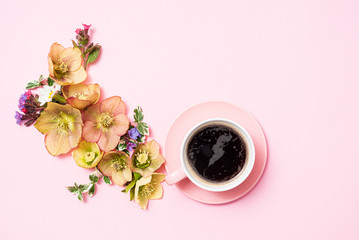 cup of coffee and flowers on the pink background