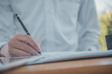 Close up hand write on paperwork,Man work from home