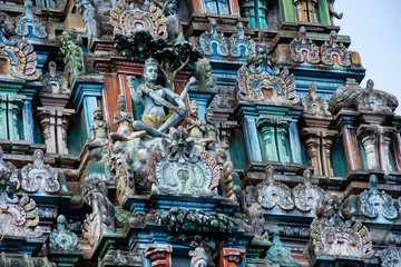 Hindu temple in Tamil Nadu, South India.  Sculptures on Hindu temple gopura (tower), sculpture of an Indian deity