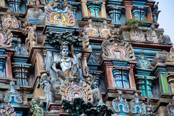 Hindu temple in Tamil Nadu, South India.  Sculptures on Hindu temple gopura (tower), sculpture of an Indian deity