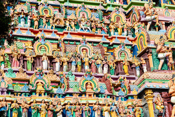 Fototapeta na wymiar Hindu temple in Tamil Nadu, South India. Sculptures on Hindu temple gopura (tower), sculpture of an Indian deity