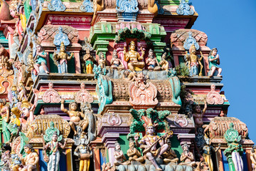 Hindu temple in Tamil Nadu, South India.  Sculptures on Hindu temple gopura (tower), sculpture of an Indian deity