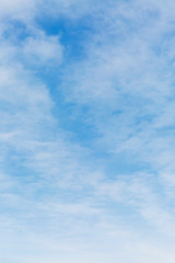 Naklejka na ściany i meble Bright blue sky in the clouds on a sunny day. Space for text. Background. Vertical.