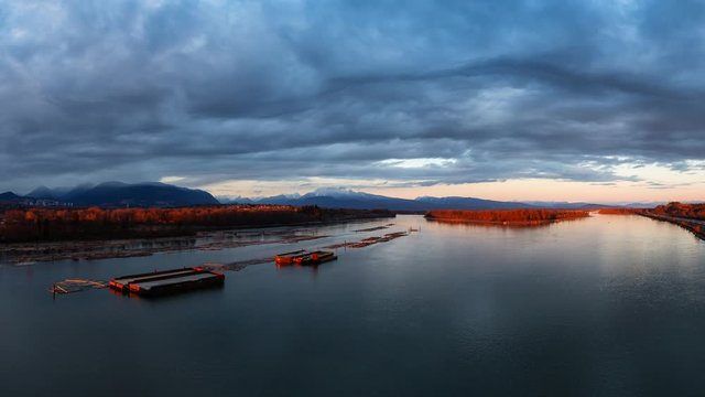 Cinemagraph Continuous Loop Animation. Beautiful Aerial Panoramic View of Fraser River during a colorful sunset. Taken from Port Mann Bridge, Vancouver, British Columbia, Canada.