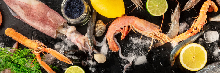 Seafood panoramic overheaed shot. Fresh shrimps, sardines, squid, mussels, clams and caviar on ice