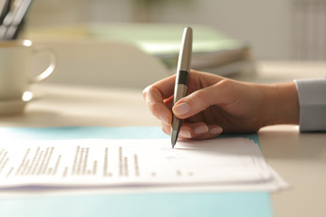 Business woman hands signing contract at the office