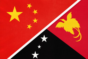 China or PRC vs Papua New Guinea national flag from textile. Relationship between Asian and Oceania countries.