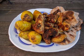 homemade grilled spicy wings and potatoes