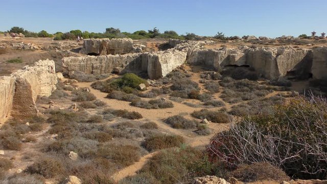 Bright blue sky, beautiful day. The ruins of the necropolis Royal Tombs. Filmed on the territory of the archaeological park Royal Tombs, near Paphos, Cyprus.