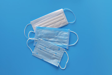 Three medical protective mask isolated on blue background