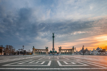 Budapest, Hungary - No people and tourists on the totally empty Heroes' Square on a morning day during 2020 Coronavirus disease quarantine with a beautiful sunrise at background