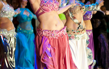 Women dance oriental dances in colored dresses