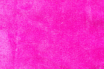 Pink matte background of suede fabric, closeup. Velvet texture of pastel leather