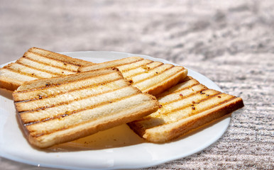 Toasted sliced bread, seasoned with olive oil