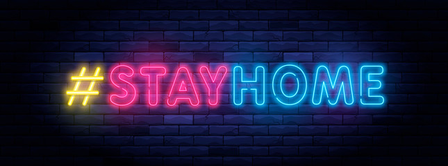Fototapeta na wymiar I Stay home hashtag in neon style. Coronavirus pandemic protection and prevention effort. Social activity message. Self-isolation and quarantine. To stay at home brightly illuminated neon sign on wall
