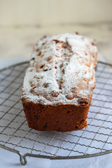 Freshly baked loaf cake with raisins on beautiful table. Garnished with powder sugar. 

