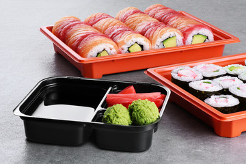 Sushi maki with salmon, shrimp and avocado, sushi philadelphia, soy sauce, wasabi and ginger in a...