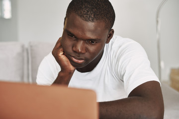 man sitting on sofa with laptop