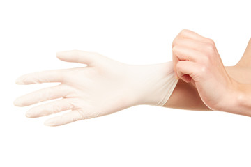 Woman's hands putting on surgical gloves