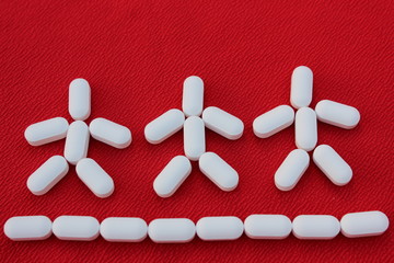 Man from tablets on a red background. People made of drugs isolated on white. Medicine concept....