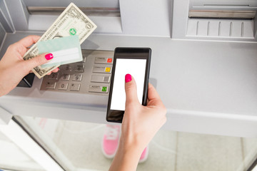 Woman using modern ATM nashine - cash withdrawal.