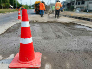 Motion blur, road construction with a red rubber cone in front