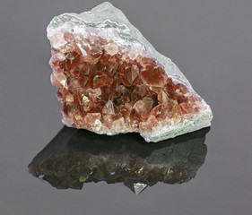 red ruby in geode on grey background