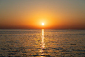 The sun is setting over the ocean